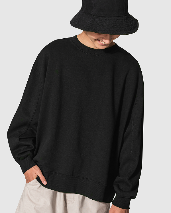 Creative professional in black bucket hat and sweatshirt smiling